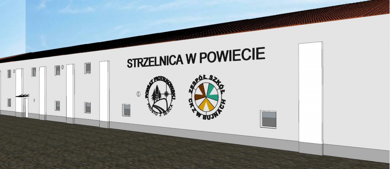 Wizualizacja budynku Strzelnicy. Na ścianie napis Strzelnica w Powiecie oraz logo Powiatu Piotrkowskiego prosto z serca oraz logo szkoły w Bujnach.